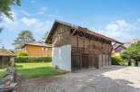 Discover this charming property featuring a rustic wooden barn, perfect for storage or a workshop.