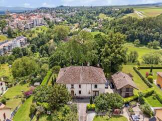 Discover this stunning property nestled in a serene, green landscape.