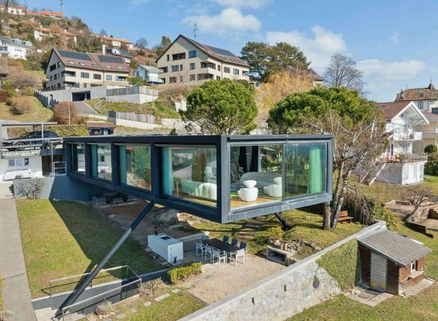 This stunning modern home boasts a unique cantilevered design, offering breathtaking views and a seamless connection to the outdoors.