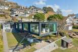This stunning modern home boasts a unique cantilevered design, offering breathtaking views and a seamless connection to the outdoors.