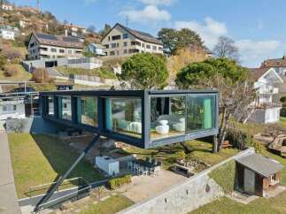 This stunning modern home boasts a unique cantilevered design, offering breathtaking views and a seamless connection to the outdoors.