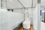 Experience luxury in this modern bathroom featuring a sleek, freestanding bathtub and a separate shower area.