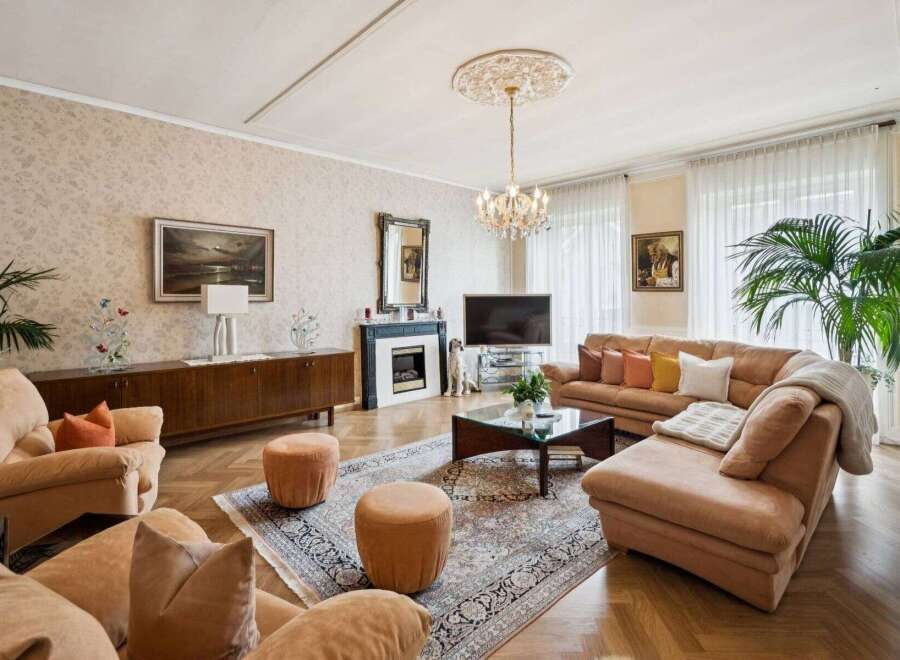 Step into luxury with this stunning living room, featuring a cozy seating area and a beautiful fireplace.