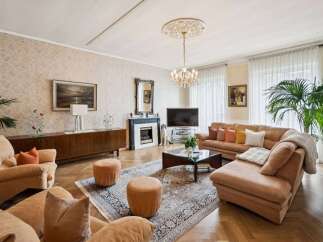 Step into luxury with this stunning living room, featuring a cozy seating area and a beautiful fireplace.