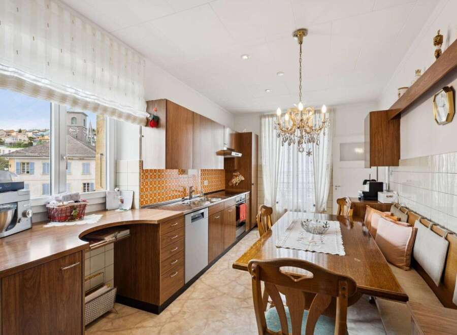 Step into this charming kitchen, featuring warm wooden cabinetry and a unique tile backsplash that adds character.