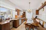 Step into this charming kitchen, featuring warm wooden cabinetry and a unique tile backsplash that adds character.