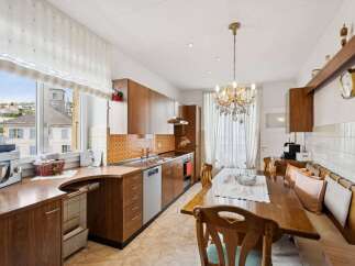 Step into this charming kitchen, featuring warm wooden cabinetry and a unique tile backsplash that adds character.