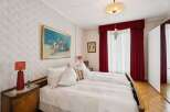 This elegant bedroom features a comfortable bed with plush pillows, perfect for a relaxing retreat.