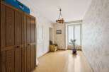 Discover the charm of this inviting room, featuring a beautiful wooden wardrobe and elegant white doors.
