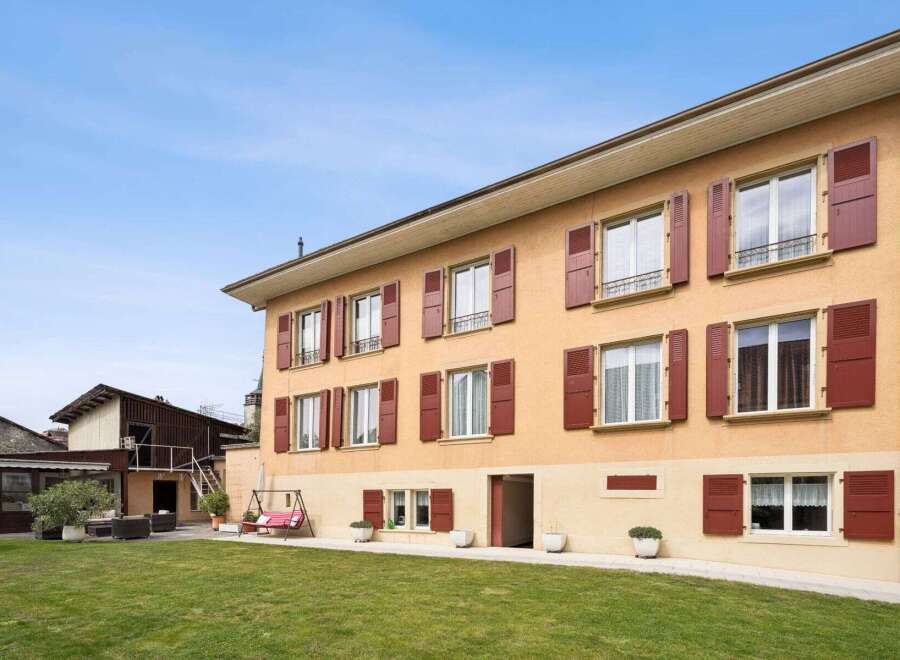 Discover this charming property featuring a classic facade with multiple windows and shutters.
