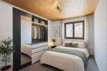 Discover the charm of this cozy bedroom, featuring a stylish wardrobe with ample storage and a full-length mirror.