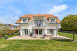 Discover your dream home! This stunning property boasts a beautiful exterior with a charming red-tiled roof and elegant shutters.