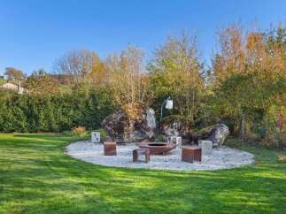 Discover the perfect outdoor oasis in this stunning property! Featuring a beautifully designed fire pit area, ideal for cozy gatherings and entertaining.