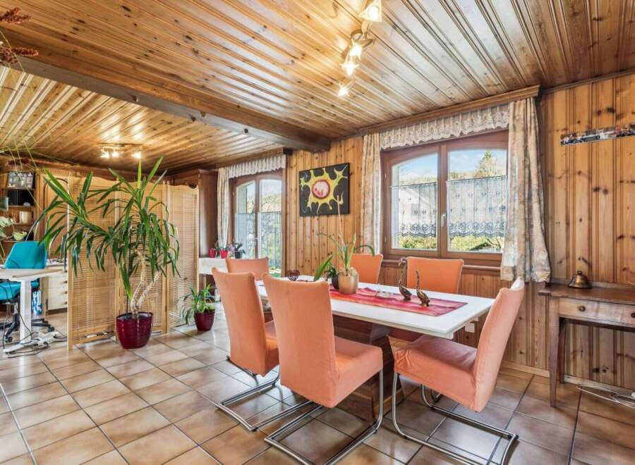 Step into a charming dining room with a rustic ambiance, featuring warm wooden paneling and a cozy atmosphere.