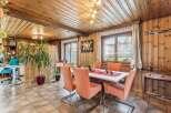 Step into a charming dining room with a rustic ambiance, featuring warm wooden paneling and a cozy atmosphere.