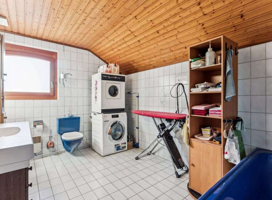 This charming property boasts a unique combination of functionality and style, featuring a dedicated laundry area with modern appliances.