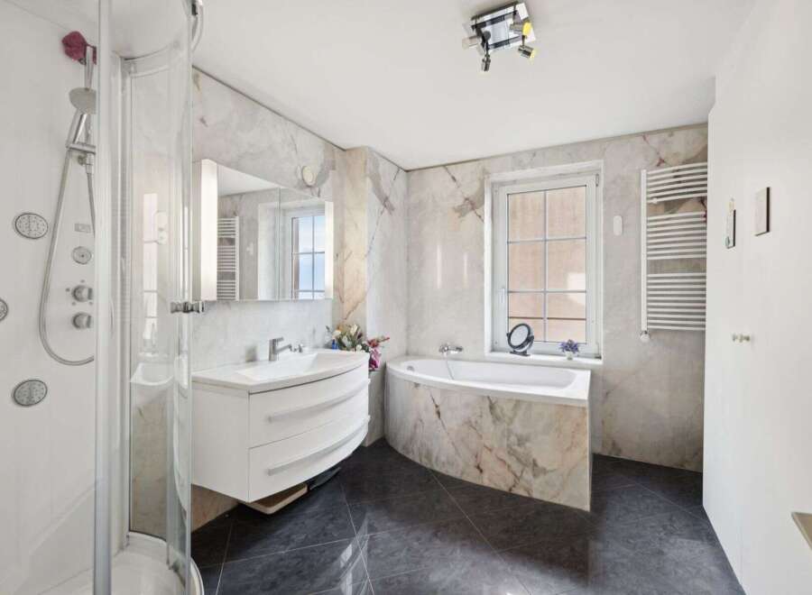 Step into luxury with this stunning bathroom featuring a sleek, modern design.