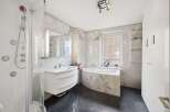 Step into luxury with this stunning bathroom featuring a sleek, modern design.