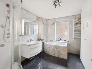 Step into luxury with this stunning bathroom featuring a sleek, modern design.