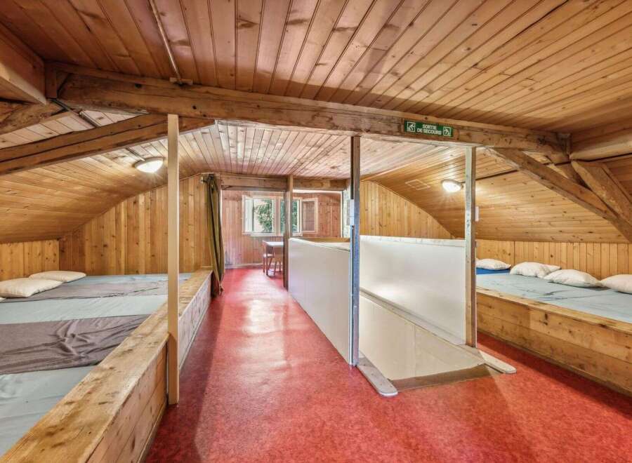 Discover the charm of this unique property, featuring a cozy, wooden-paneled interior.