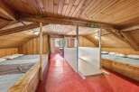 Discover the charm of this unique property, featuring a cozy, wooden-paneled interior.