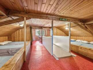 Discover the charm of this unique property, featuring a cozy, wooden-paneled interior.