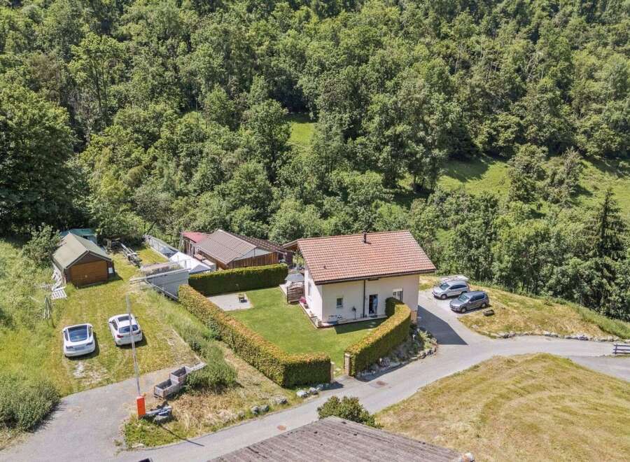 Nestled in a serene, wooded landscape, this charming property offers a tranquil retreat.