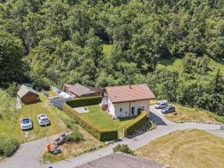 Nestled in a serene, wooded landscape, this charming property offers a tranquil retreat.