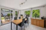 This bright and airy dining room offers a perfect blend of indoor and outdoor living.