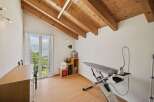 This charming property boasts a bright and airy interior with a unique sloped ceiling and exposed wooden beams.