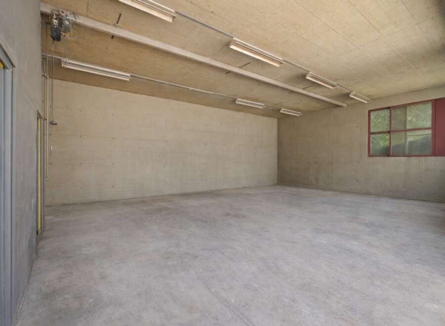 This spacious, empty room offers a blank canvas for various uses, from storage to a workshop.