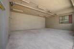 This spacious, empty room offers a blank canvas for various uses, from storage to a workshop.