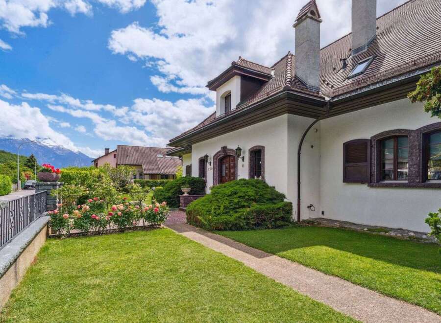 Discover this stunning property featuring a charming exterior and lush landscaping.