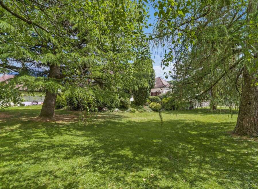 Discover the tranquility of this stunning property, featuring a lush, expansive lawn perfect for outdoor activities.