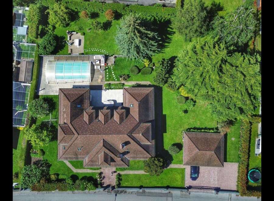 Discover luxury living in this stunning property featuring a private pool and expansive green spaces.