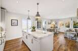 This stunning kitchen boasts a spacious island with elegant marble countertops, perfect for meal preparation and entertaining.