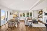 This stunning property boasts a spacious open-concept living and dining area, perfect for entertaining.