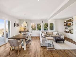This stunning property boasts a spacious open-concept living and dining area, perfect for entertaining.