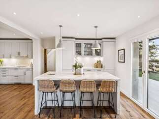 This stunning kitchen boasts a modern design with a spacious island, perfect for entertaining.
