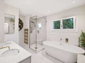 Step into luxury with this stunning bathroom featuring a sleek, modern design.