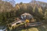 Nestled amidst lush greenery, this stunning property offers a serene retreat.