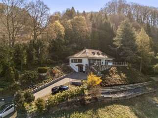 Nestled amidst lush greenery, this stunning property offers a serene retreat.