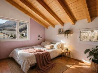 This cozy bedroom features a stunning wooden ceiling and a large window offering breathtaking mountain views.