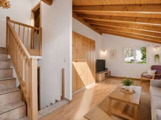 This stunning property boasts a warm and inviting interior with beautiful wooden accents throughout.