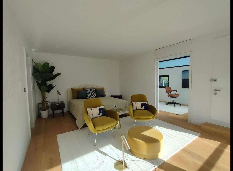 Step into luxury with this stunning bedroom featuring a modern design and ample natural light.