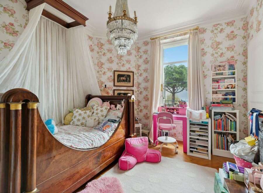 This charming bedroom features a canopy bed, creating a cozy and inviting atmosphere.