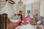 This charming bedroom features a canopy bed, creating a cozy and inviting atmosphere.