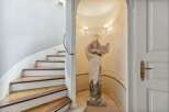 Step into luxury with this stunning property featuring a grand staircase and an elegant statue.