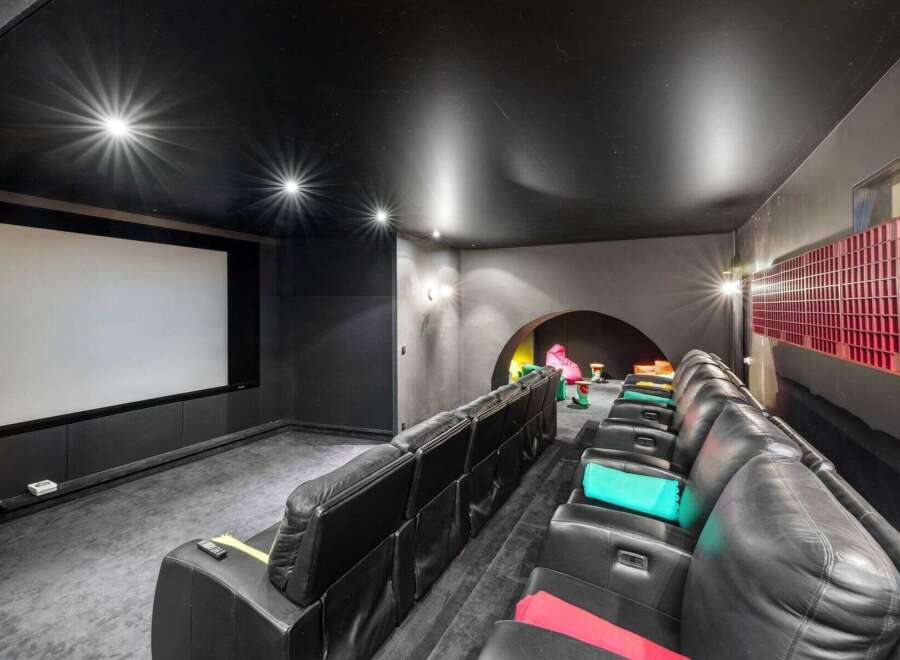 Step into luxury with this stunning home theater! Featuring plush black leather seating, a massive screen, and a sleek, modern design, it's the perfect space for movie nights.