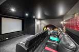 Step into luxury with this stunning home theater! Featuring plush black leather seating, a massive screen, and a sleek, modern design, it's the perfect space for movie nights.